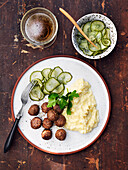 Meatballs, mashed potatos with cauliflower and pickled cucumber