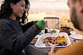 Couple enjoying seafood lunch on patio