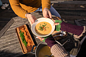 Couple with fresh chowder on sunny patio