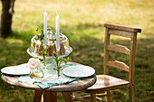 Candlesticks and cake on summer garden table