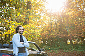 Happy man in convertible in sunny autumn park