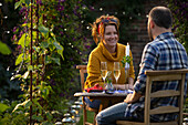 Happy couple enjoying champagne at garden table