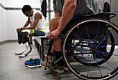 Paraplegic athlete in wheelchair in locker room