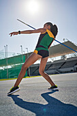 Female track and field athlete throwing javelin