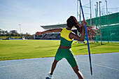 Female track and field athlete throwing javelin