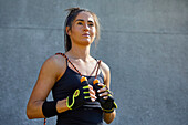 Confident female athlete with jump rope