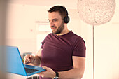 Man with headphones working from home