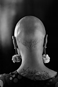 Woman with shaved head and tattoos