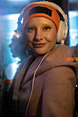 Happy woman with headphones and stocking cap