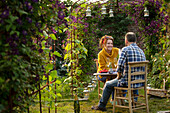 Happy couple enjoying champagne in summer garden