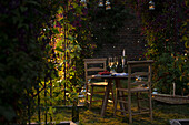 Champagne and red currants on summer garden table