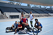 Confident track and field athletes on sunny track