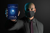 Businessman in face mask with Covid-19 immunity passport