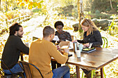 Business people meeting and eating lunch at table in park