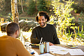 Businessmen eating lunch and discussing paperwork