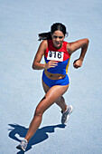 Determined athlete running on sunny track