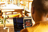 Restaurant owner reviewing online delivery on digital tablet