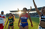 Happy athletes celebrating in stadium