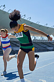 Female athletes at competition finish line on track
