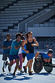 Happy athletes on sunny sports track