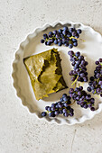 Feta baked in grape leaves served with grapes