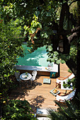 Terrace with deckchairs, bistro table and swimming pool