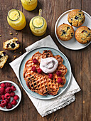 Waffels chith chocolate, raspberries and whipped cream. Muffins and smoothie