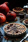 Pumpkin pie with spider web decorations