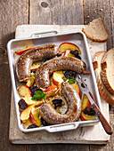 White pudding (tripe sausage) baked with apples and dried plums