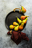 Organic ripe pear fruits on metal vintage plate