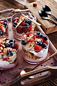Dessert with raspberry mousse, fresh raspberries, homemade granola and bananas