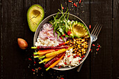 A veggie bowl with carrots, lentils and avocado