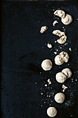Walnut macaroons on a black surface