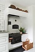 Old wood-burning stove in white kitchen