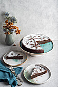 Chocolate cake decorated with icing sugar and snow flakes