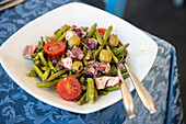 Sicilian octopus salad with olives, onions, green beans and tomatoes