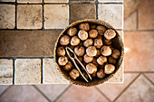 bowl of walnuts on a rustic tile table
