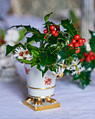 Bouquet of holly with berries and asters