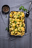 Gratinated vegan potato and Brussels sprouts bake, with almond cheese
