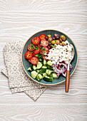 Greek mediterranean salad with tomatoes, feta cheese, cucumber, whole olives and red onion