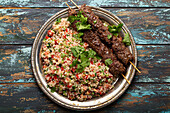 Middle eastern Turkish dinner with meat kebab and couscous salad tabbouleh