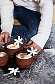 Hot chocolate with marshmallows and snowflake decoration on a fluffy blanket