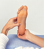 Bare foot being massaged