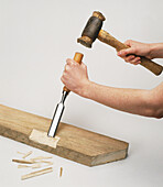 Chiselling a wooden plank