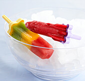 Two ice lollies in bowl of ice