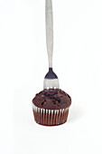 Stainless steel fork in chocolate cup cake