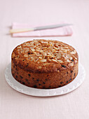 Fruit cake topped with almond flakes