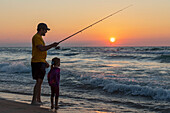 Father and daughter fishing on Lake Michigan, USA