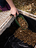Adding gravel to a lined hamper