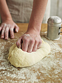 Kneading bread dough on floured surface